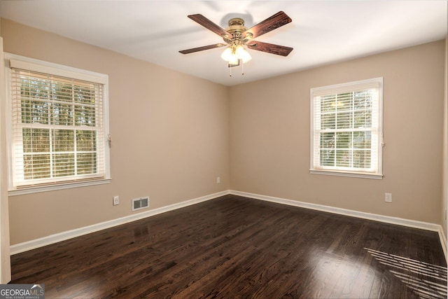 empty room featuring dark hardwood / wood-style floors and ceiling fan