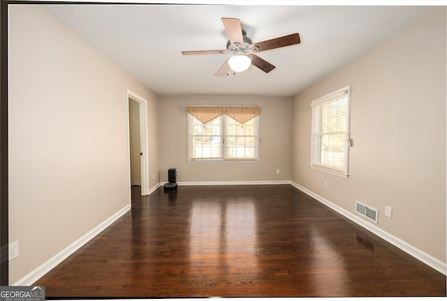 spare room with ceiling fan and dark hardwood / wood-style flooring