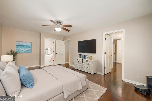 bedroom with ceiling fan, ensuite bath, and dark hardwood / wood-style flooring