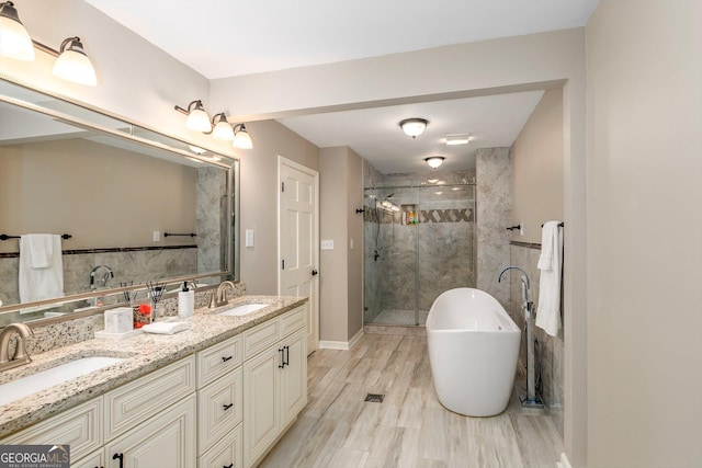 bathroom featuring vanity, shower with separate bathtub, and hardwood / wood-style floors