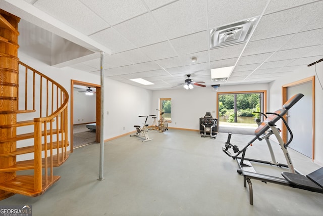 exercise room with a drop ceiling and ceiling fan