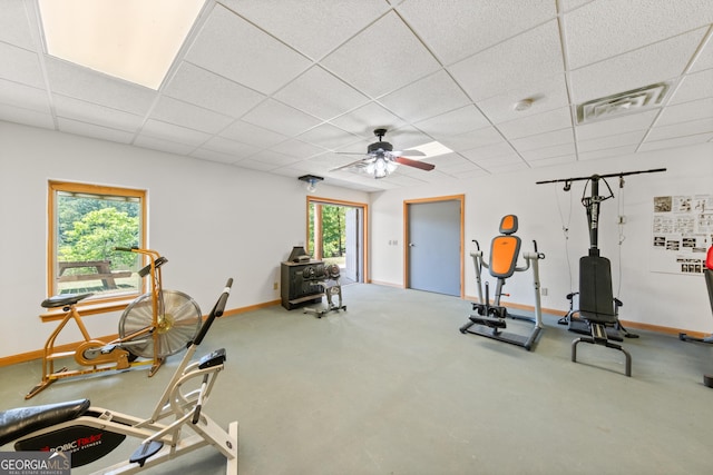 exercise area featuring a drop ceiling and ceiling fan