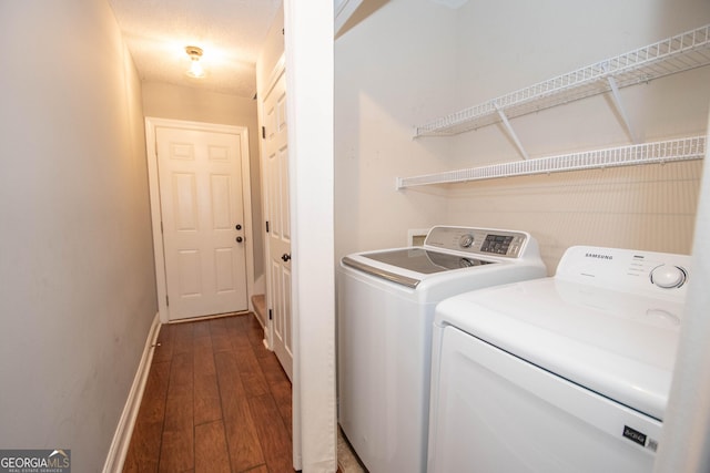 washroom with separate washer and dryer and dark hardwood / wood-style floors