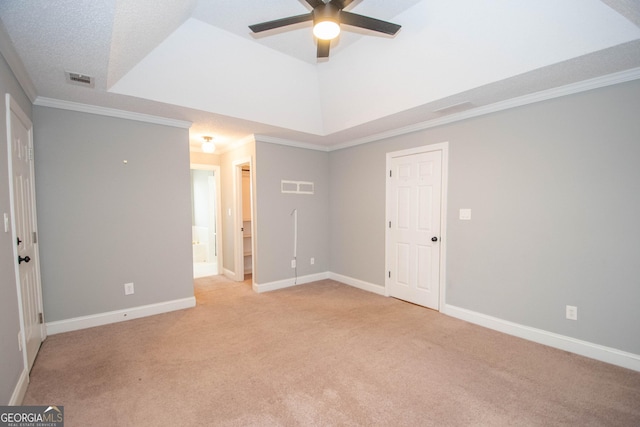 unfurnished room with crown molding, light colored carpet, and a tray ceiling