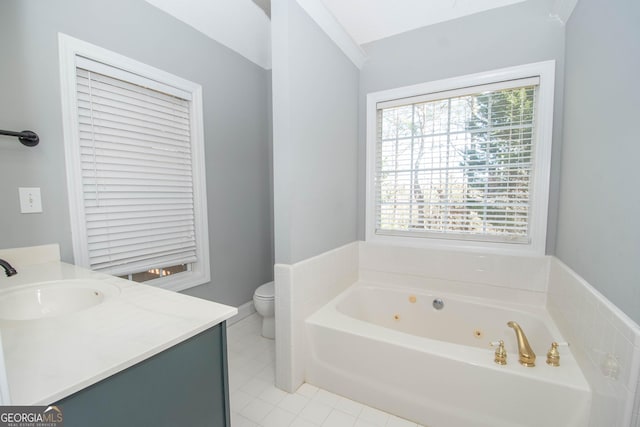 bathroom featuring vanity, a tub to relax in, tile patterned floors, and toilet