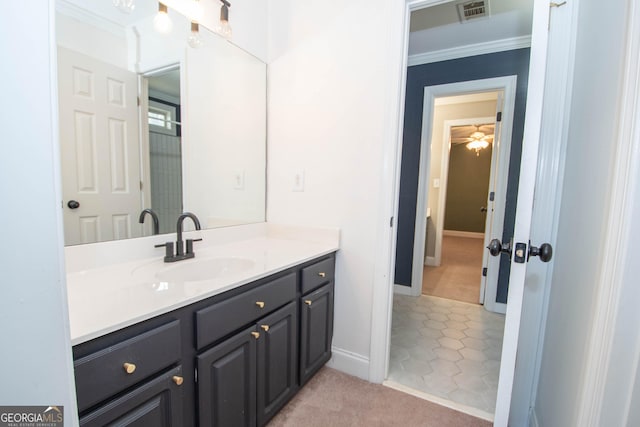 bathroom featuring vanity, tile patterned floors, and crown molding