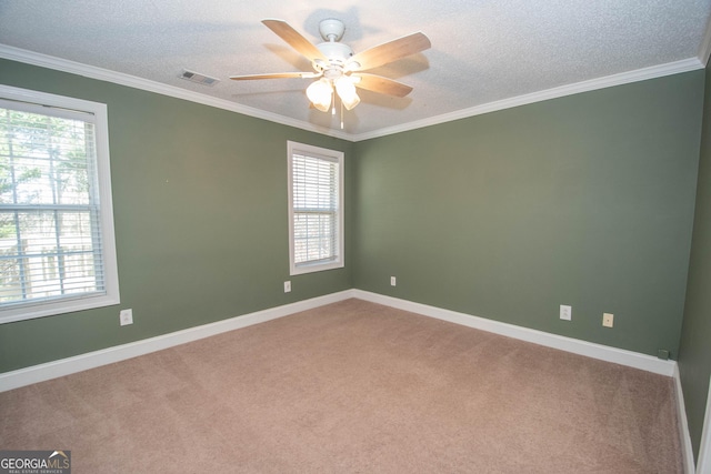 spare room featuring crown molding, ceiling fan, and carpet