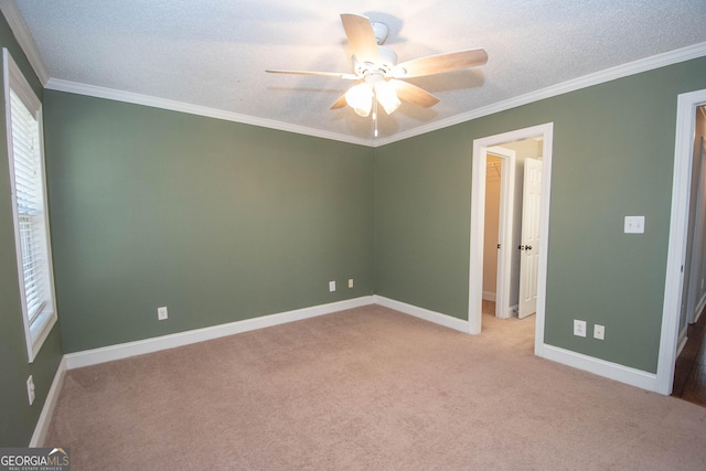 unfurnished bedroom featuring crown molding, ceiling fan, light carpet, and a textured ceiling