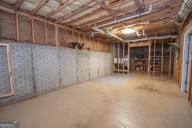 basement with brick wall