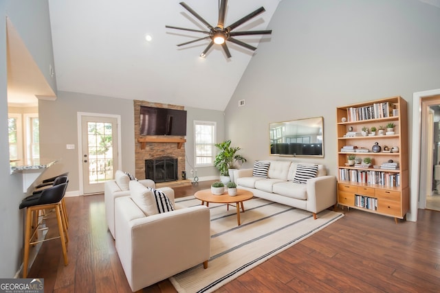 living room featuring plenty of natural light, dark wood-type flooring, high vaulted ceiling, and a fireplace