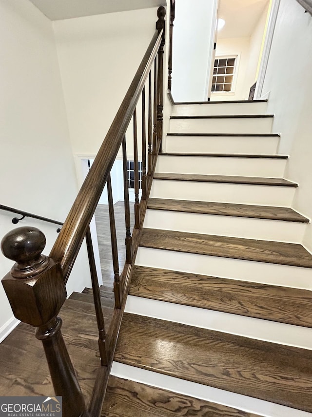 stairway with hardwood / wood-style floors