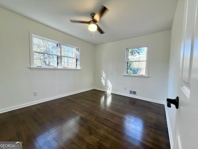 spare room with ceiling fan and dark hardwood / wood-style flooring