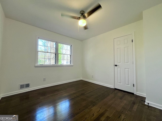 empty room featuring dark hardwood / wood-style floors and ceiling fan