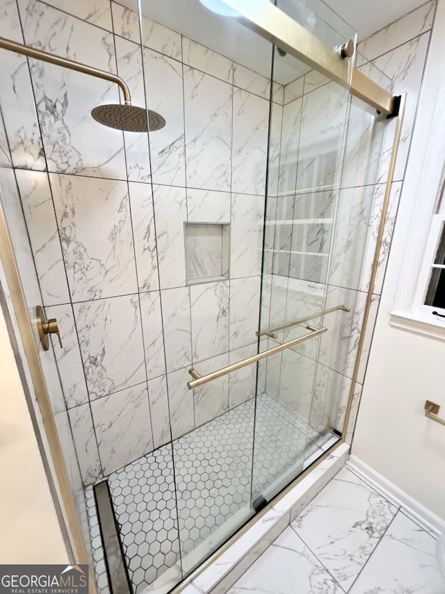 bathroom with a shower with door