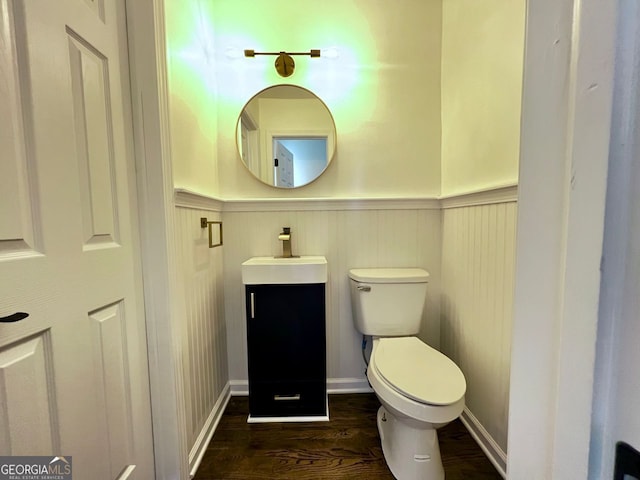 bathroom with vanity, hardwood / wood-style flooring, and toilet