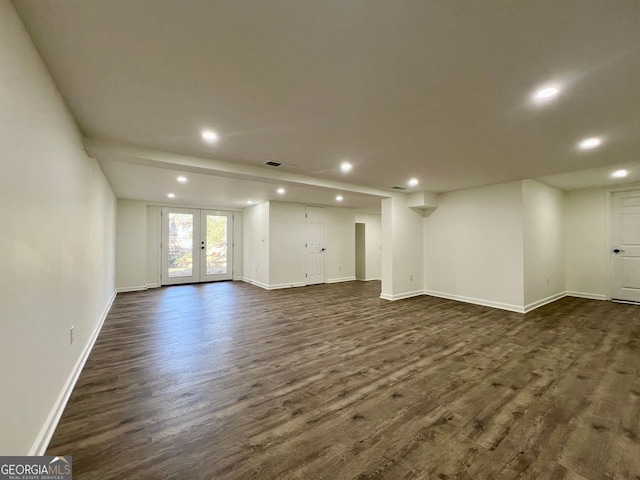 unfurnished living room featuring dark wood-type flooring and french doors