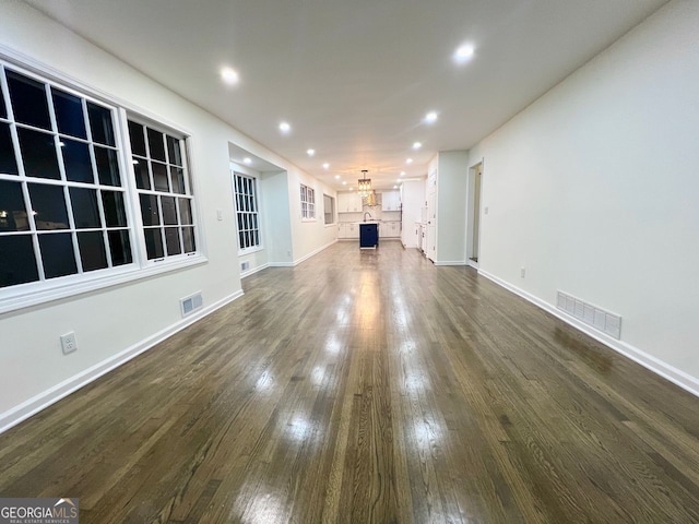 unfurnished living room with dark hardwood / wood-style flooring