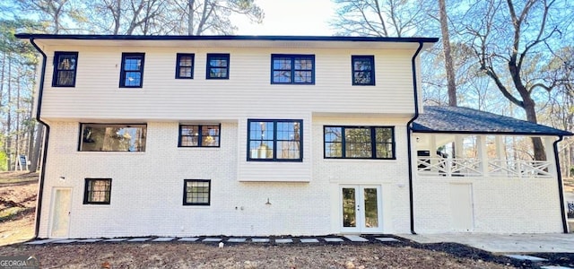 back of property featuring a patio area, french doors, and a balcony