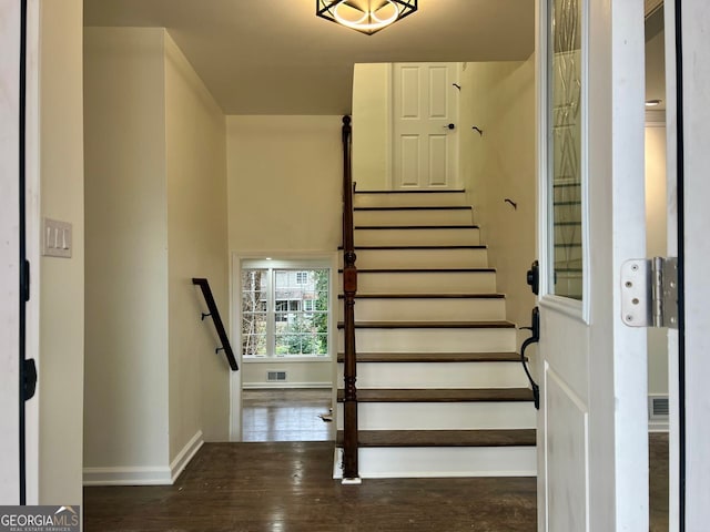 stairs featuring hardwood / wood-style flooring