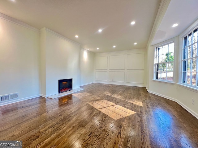 unfurnished living room featuring dark hardwood / wood-style floors and ornamental molding