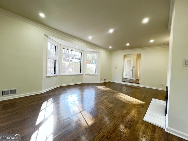 spare room featuring crown molding and dark wood-type flooring