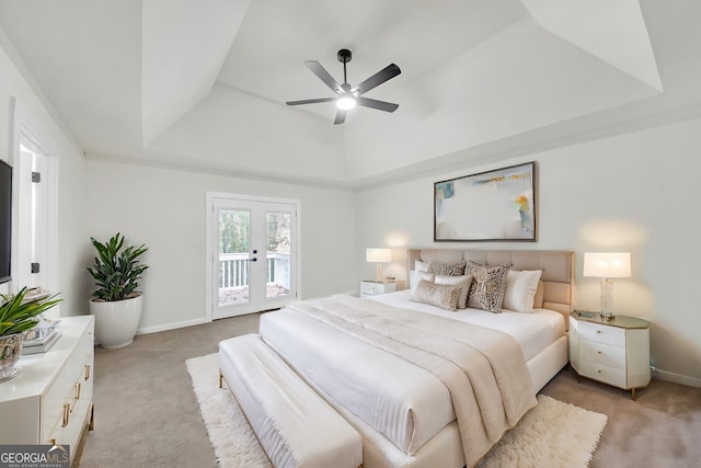 bedroom with light carpet, french doors, access to outside, a raised ceiling, and ceiling fan