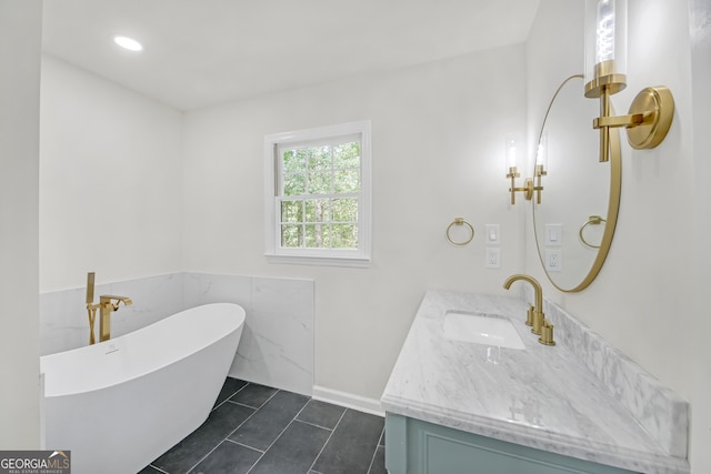 bathroom with tile patterned flooring, vanity, and a bathtub