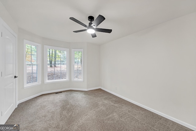 carpeted spare room with ceiling fan