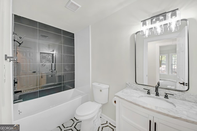 full bathroom with tile patterned floors, vanity, tiled shower / bath combo, and toilet