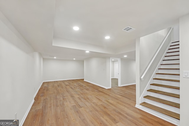 basement with light hardwood / wood-style flooring