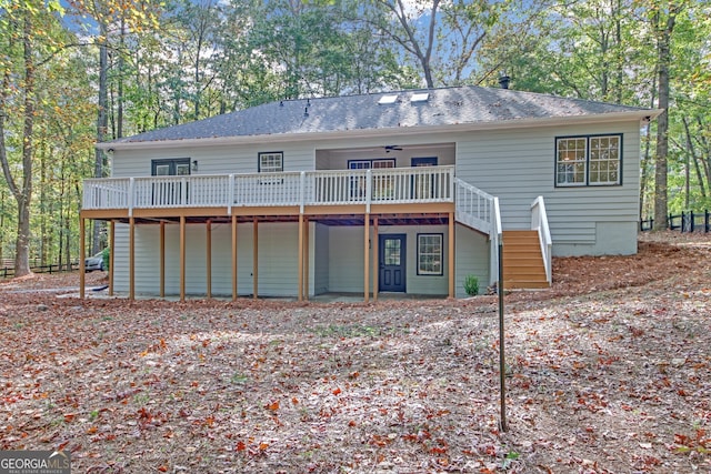 rear view of house with ceiling fan and a deck