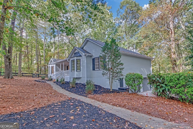 view of side of property featuring a porch and a garage