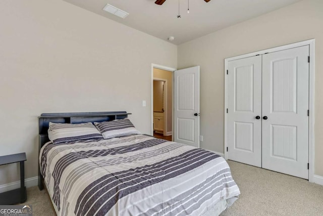 carpeted bedroom with ceiling fan and a closet