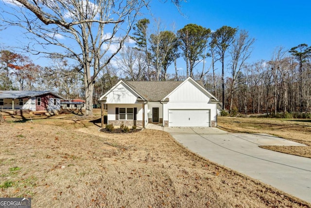 modern farmhouse with a front yard and a garage