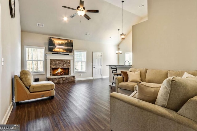 living room with a fireplace, dark hardwood / wood-style floors, high vaulted ceiling, and ceiling fan