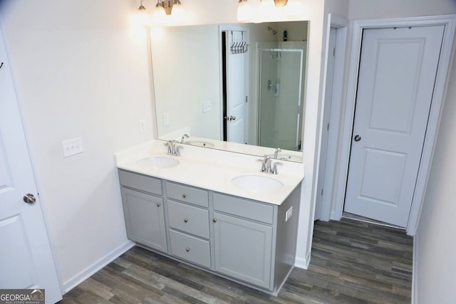 bathroom with vanity, hardwood / wood-style flooring, and walk in shower