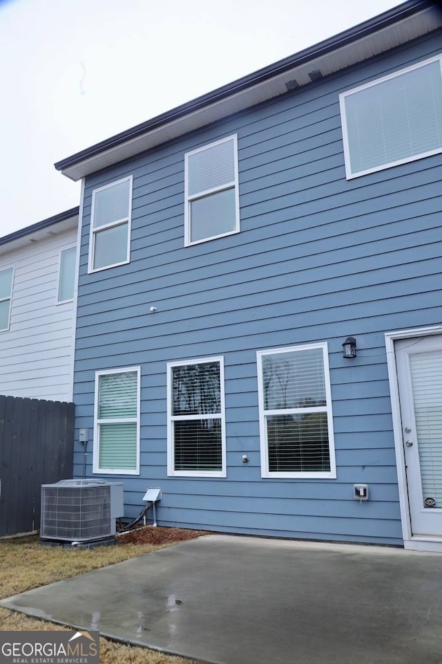 back of property featuring central AC and a patio area