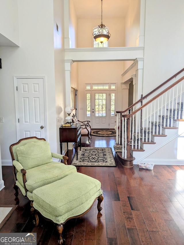 foyer with a high ceiling and dark hardwood / wood-style flooring