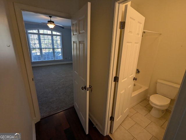 bathroom with toilet, tile patterned floors, and ceiling fan