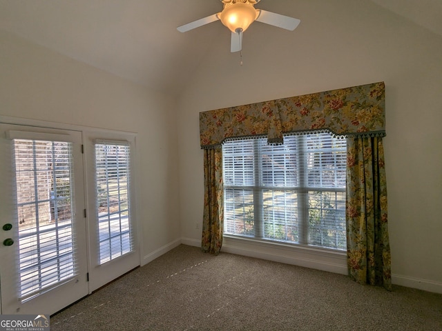 carpeted spare room with ceiling fan and lofted ceiling