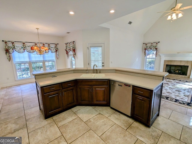 kitchen with dark brown cabinets, dishwasher, sink, and decorative light fixtures