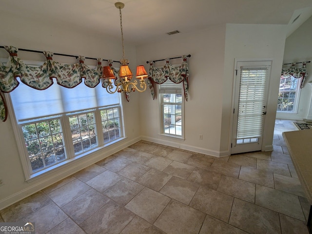 unfurnished dining area with a notable chandelier