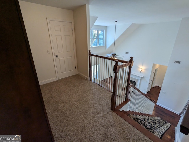 stairs with carpet and ceiling fan