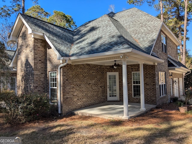 rear view of house with ceiling fan and a patio