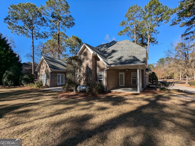 view of front of home with a front lawn, a patio, and ceiling fan