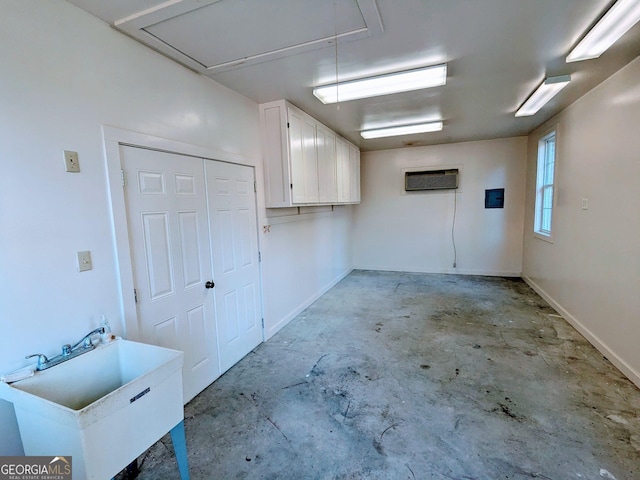 garage featuring sink and a wall unit AC