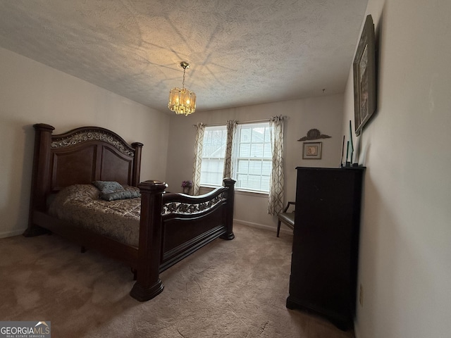 carpeted bedroom with a notable chandelier and a textured ceiling