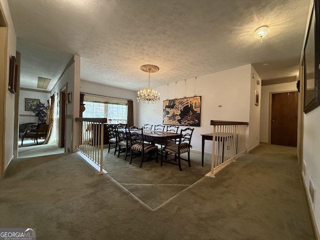 dining space with a chandelier, dark carpet, and a textured ceiling