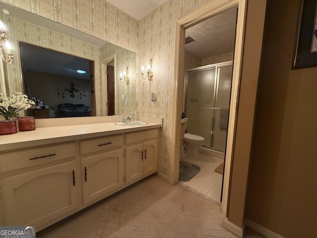 bathroom with vanity, toilet, and walk in shower