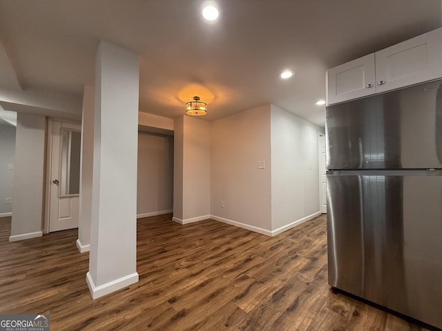 kitchen featuring stainless steel refrigerator, white cabinetry, and dark hardwood / wood-style flooring